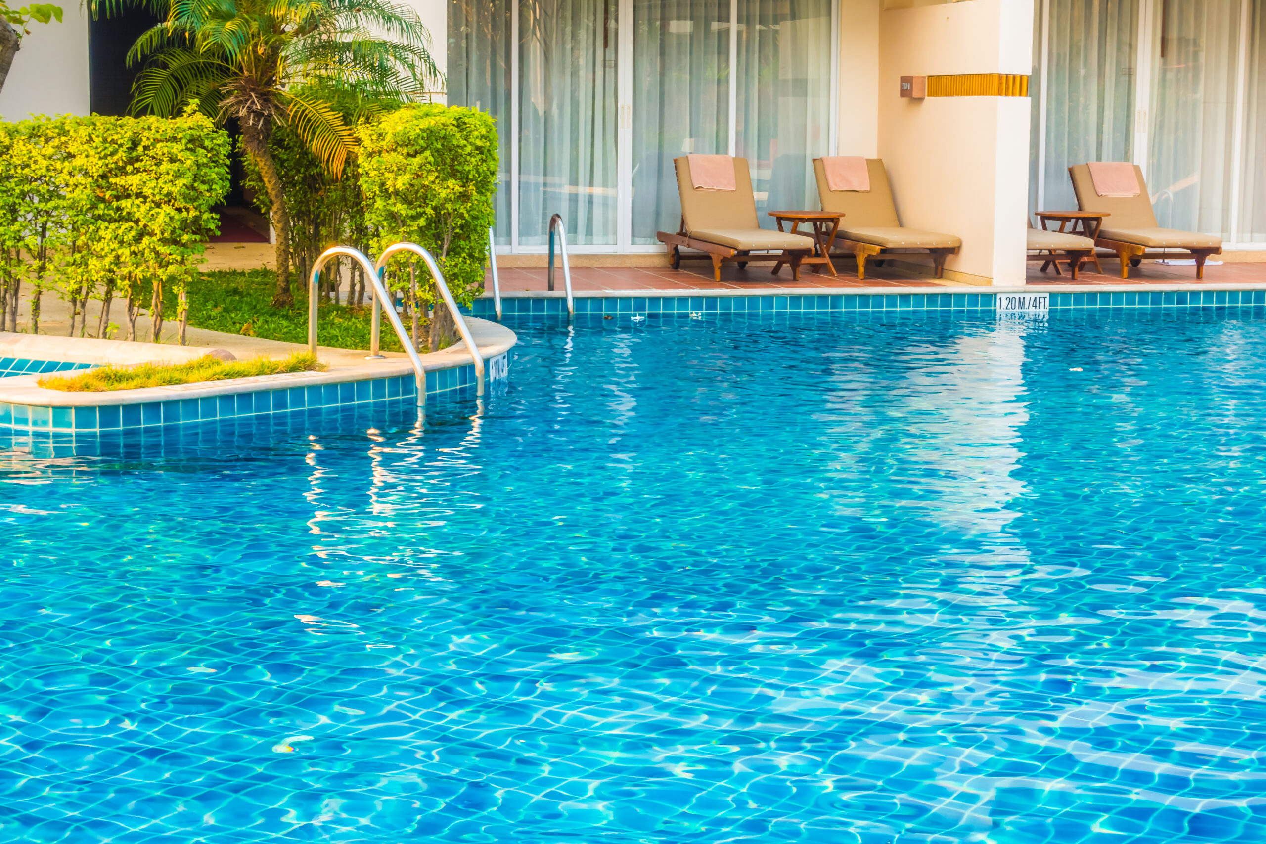 Pool with blue water and chairs